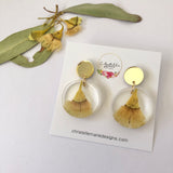 Small round resin dangle with yellow gum blossom and gold top