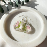 Small tear drop Queen Anne’s lace dangles on hook,