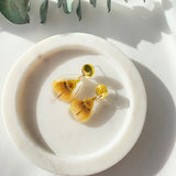 Small tear drop resin dangle with yellow gum blossom