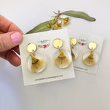 Small round resin dangle with yellow gum blossom and gold top