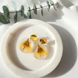 Small round resin dangle with yellow gum blossom and gold top