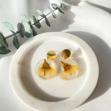 Small round resin dangle with yellow gum blossom and gold top