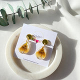 Small tear drop resin dangle with yellow gum blossom