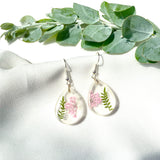 Small tear drop Queen Anne’s lace dangles on hook,