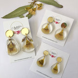 Small round resin dangle with yellow gum blossom and gold top
