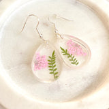 Small tear drop Queen Anne’s lace dangles on hook,