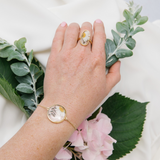 Gold oblong adjustable size ring with white daisies